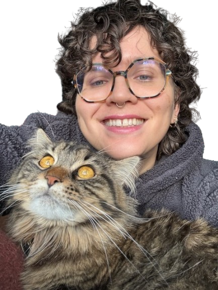 Flo, smiling, holding Mushroom the cat